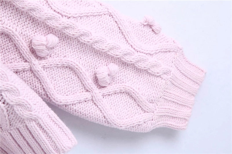 KNIT SWEATER WITH POMPOMS
